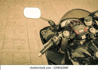 A sporty motorcycle parked in front of a coffee shop - Powered by Shutterstock