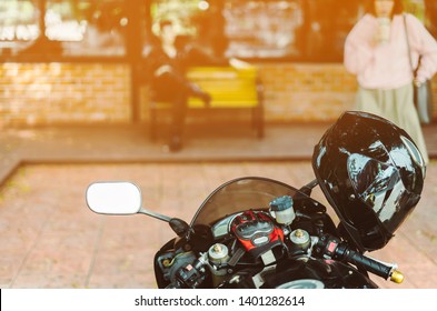 A sporty motorcycle parked in front of a coffee shop - Powered by Shutterstock