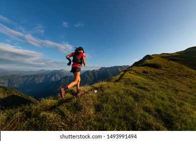 Sporty mountain woman rides in trail during endurance trail - Shutterstock ID 1493991494