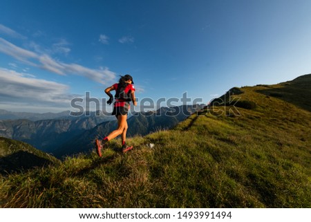 Sporty mountain woman rides in trail during endurance trail