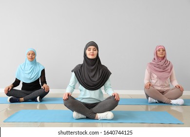 Sporty Muslim women practicing yoga in gym - Powered by Shutterstock