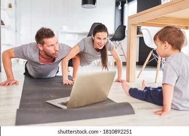 Sporty Parents Do Sports In Front Of The Laptop Computer While Streaming Video