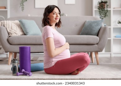 Sporty pregnant woman at home - Powered by Shutterstock