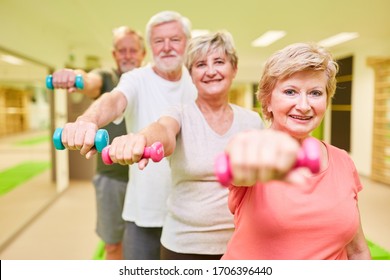 Sporty Senior Group With Dumbbells For Rehabilitation For Muscle Building And Strength