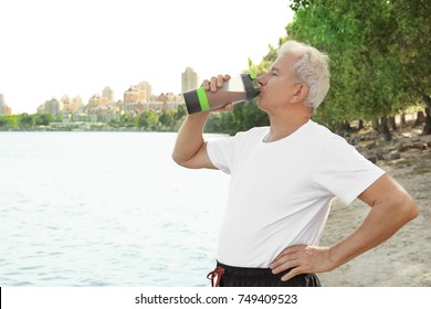 Sporty Senior Man Drinking Protein Shake, Outdoors