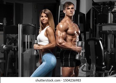 Sporty Sexy Couple Showing Muscle And Workout In Gym. Muscular Man And Woman