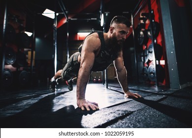 Sporty shape bodybuilder guy in military vest doing push-ups exercise in the gym. - Powered by Shutterstock