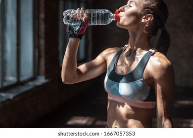 sporty thirsty fit slim woman fitness instructor bodybuilder drink bottle restore water balance before training have break,morning exercise practice workout modern gym studio healthy lifestyle concept - Powered by Shutterstock