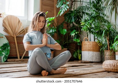 A sporty woman does exercises. Yoga asana in a fitness studio. A balance of fortitude and a healthy lifestyle. The coach is engaged in aerobics and gymnastics flexible body - Shutterstock ID 2051707646