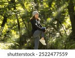 sporty woman doing a leg stretch warm up exercise outdoors in the park, autumn, fall fitness concept