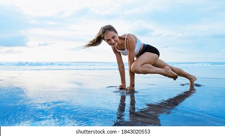 Sporty Woman Doing Mountain Climber Exercise - Run In Plank To Burn Fat. Sunset Beach, Blue Sky Background. Healthy Lifestyle At Tropical Island Yoga Retreat, Outdoor Activity, Family Summer Vacation.