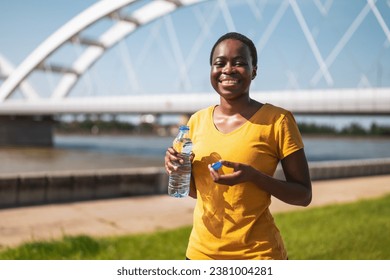 Sporty woman drinking water while  exercise outdoor. - Powered by Shutterstock