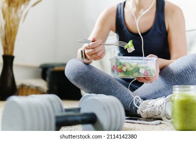 Sporty woman eating a vegetable salad after fit training.  Healthy organic food. - Shutterstock ID 2114142380