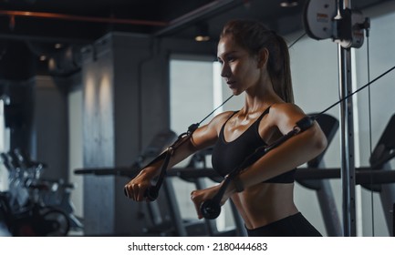 Sporty woman exercising on multistation at gym for arm and shoulders muscles. Fitness exercising in gym. - Shutterstock ID 2180444683