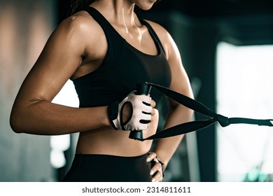 Sporty woman exercising on multistation at gym for arm and shoulders muscles. Fitness exercising in gym. - Powered by Shutterstock