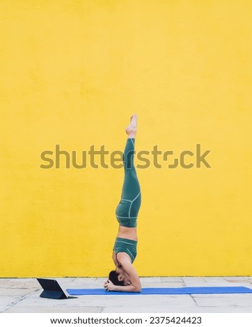 Similar – Woman doing a handstand on the beach