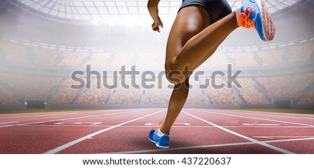 Sporty woman finishing her run against view of a stadium