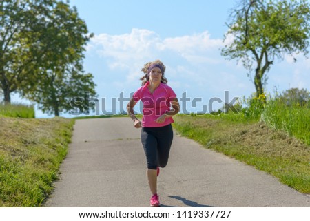 Similar – Active and sporty woman runner in autumn nature