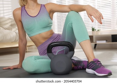 Sporty Woman With Kettlebell On Floor At Home, Closeup