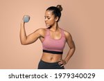 Sporty woman mockup lifting dumbbell weights in a blue background 