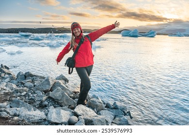 Sporty woman near Ice Glacier Lagoon Jokulsarlon over sunset. Icebergs drifting towards the sea. Great tourist spot of Iceland. - Powered by Shutterstock