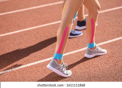Sporty woman with physio tape at stadium