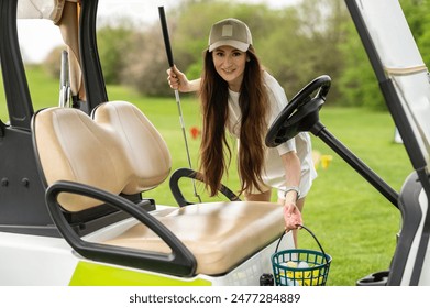 Sporty woman player posing by the car with golf equipment on the lawn - Powered by Shutterstock