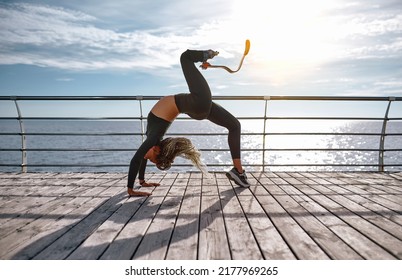 Sporty woman with prosthetic leg stretching at sunrise in the morning. Sport, motivation and fortitude concept. - Shutterstock ID 2177969265