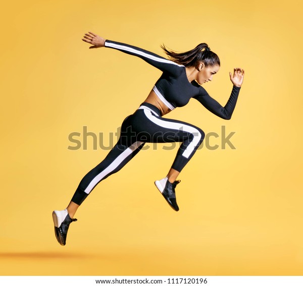 Photo of attractive woman in fashionable sportswear gym wall mural