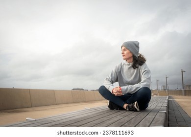 Sporty woman sitting resting after outdoor workout