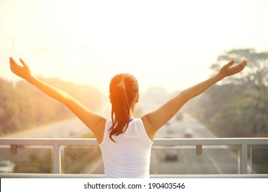 Sporty Woman Stand At The Pedestrian Overpass Open Arms To The Rush Driveway In Modern City 