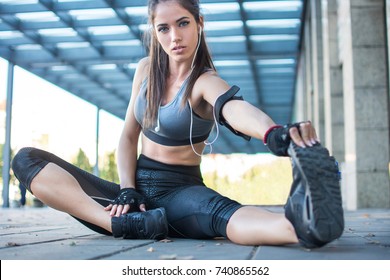 Sporty Woman Stretching Hamstring Leg Muscles During Outdoor Workout.