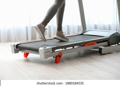 Sporty Woman Training On Treadmill At Home