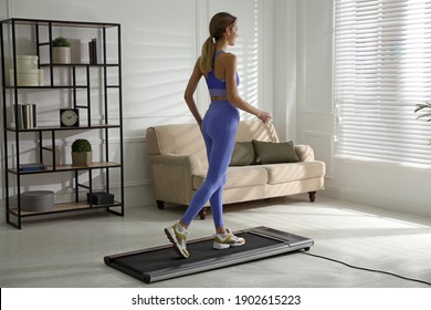 Sporty Woman Training On Walking Treadmill At Home