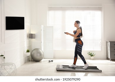 Sporty Woman Training On Walking Treadmill At Home