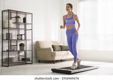 Sporty woman training on walking treadmill at home - Powered by Shutterstock