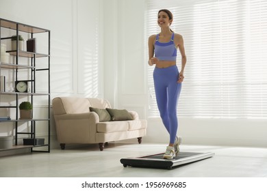 Sporty Woman Training On Walking Treadmill At Home