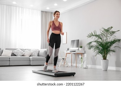 Sporty Woman Training On Walking Treadmill At Home