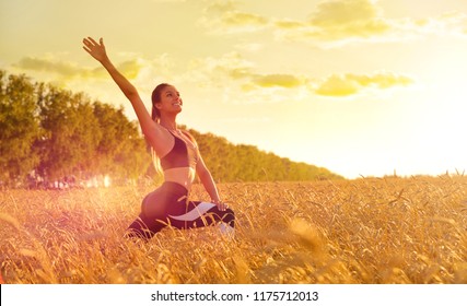 Sporty Woman In Wheat Field At Sunset