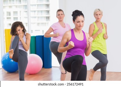 Sporty Women Practicing Kickboxing At Fitness Studio