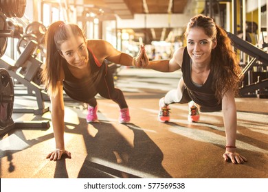 Sporty Women Working Out Together At Gym.