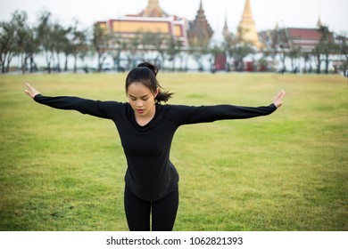 Sporty Young Asian Woman Practicing Yoga At Park.(Photo Series Of Same Model Available)