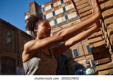 Sporty Young Black Woman Doing Wall Push Ups While Working Out Alone Outdoors During The Day