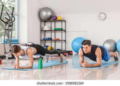 Sporty Young Couple Training In Gym