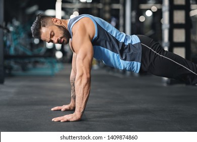 Sporty Young Man Doing Pushups In Gym, Side View, Free Space