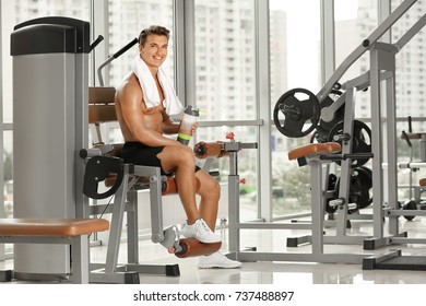 Sporty Young Man With Protein Shake In Gym