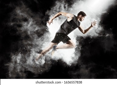 Sporty Young Man Running On Black Smoke Background