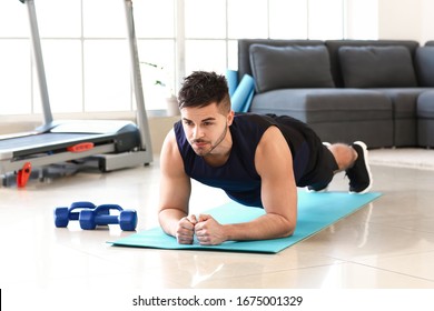 Sporty Young Man Training At Home