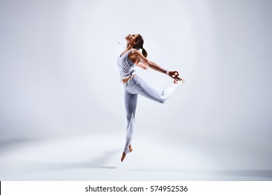 Sportliche junge Frau, die Yoga-Übungen einzeln auf weißem Hintergrund - Konzept des gesunden Lebens und des natürlichen Gleichgewichts zwischen Körper und mentaler Entwicklung