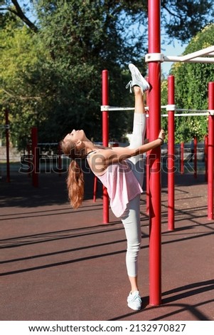 Sporty young woman exercising on sport ground